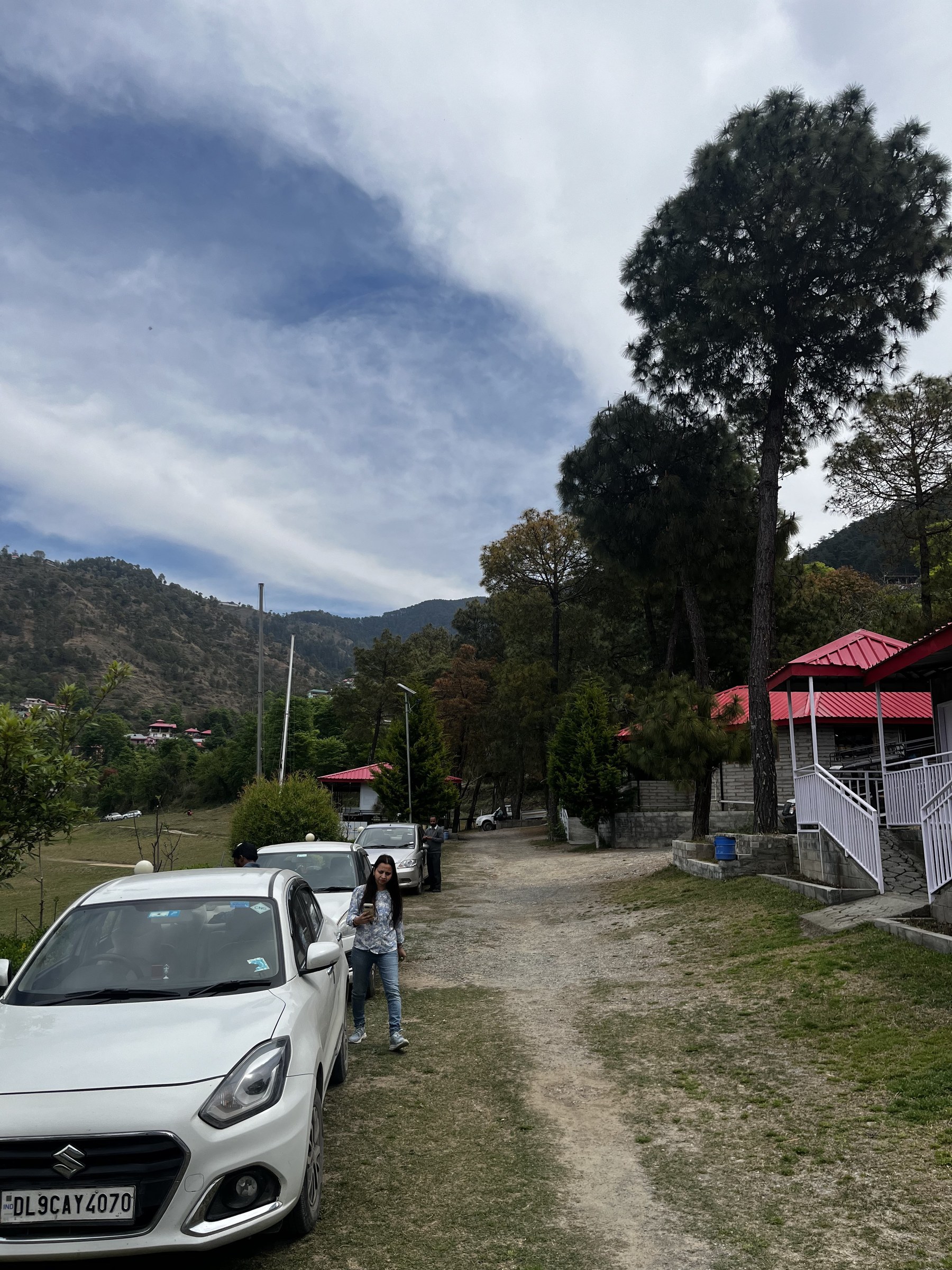 Guest arriving at The Glide Inn resort with white car and cottage visible in background