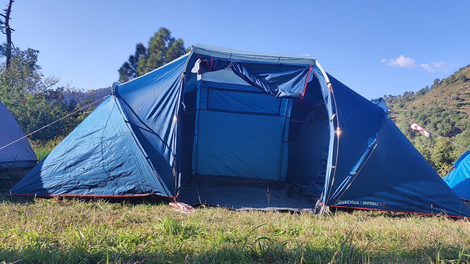 Large open blue family camping tent on hillside at The Glide Inn Shimla